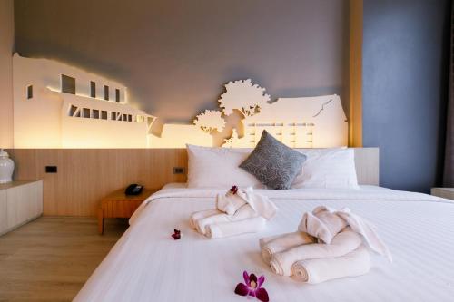 Ένα ή περισσότερα κρεβάτια σε δωμάτιο στο Hatyai Signature Hotel