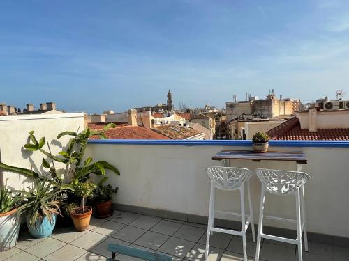 a balcony with a table and two stools at Charming home with private terrace,heart of Málaga in Málaga