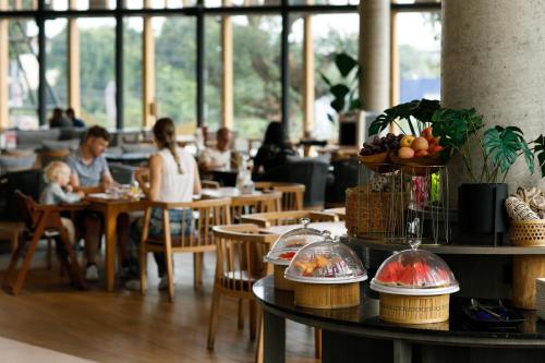 a group of people sitting at tables in a restaurant at The Signature Hotel Airport in Hat Yai