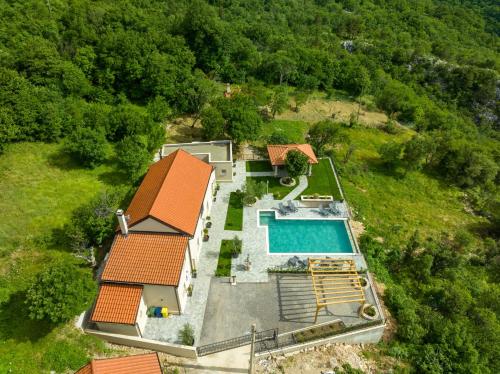 an aerial view of a house with a swimming pool at Villa Green Garden in Hreljin