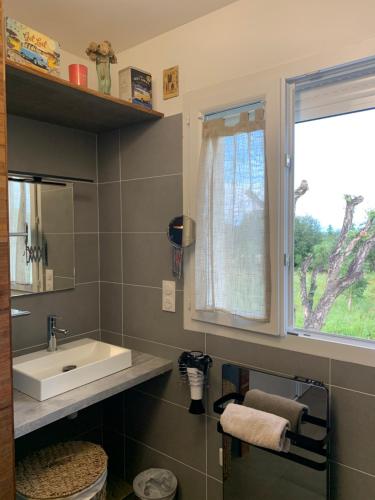 a bathroom with a sink and a window at Jolie maison Borgo trois chambres trois salles de bain in Borgo