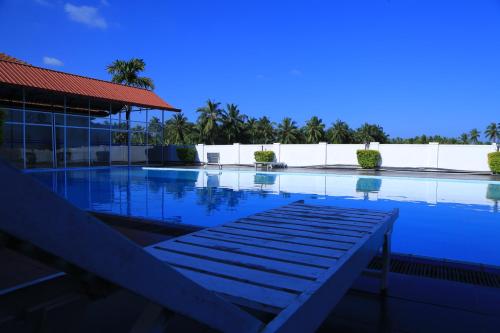 a large swimming pool next to a building at PJ Hotels Jaffna in Jaffna