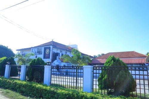 a blue fence in front of a blue house at PJ Hotels Jaffna in Jaffna