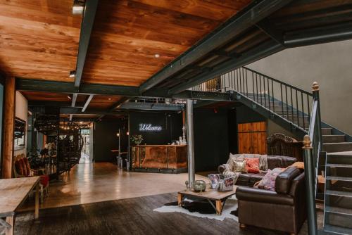 a living room with a staircase and a couch at The Narrows Landing Hotel in Hamilton