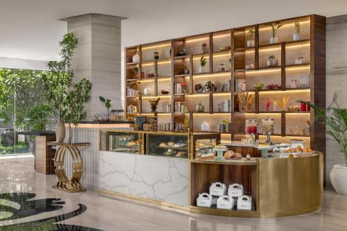 a restaurant with a counter and shelves with food at Radisson Resort & Spa Kandla in Gandhidham
