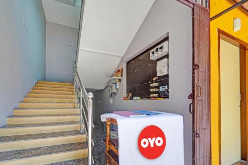 a room with stairs and a sign that says oxy at OYO Flagship Le Gith De Charme with swiming pool in Kottakupam