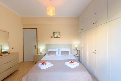 a bedroom with a bed with two towels on it at Doris House by GuestCorfu in Corfu