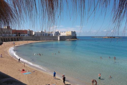 a group of people in the water at a beach at Casa del Corso in Taviano