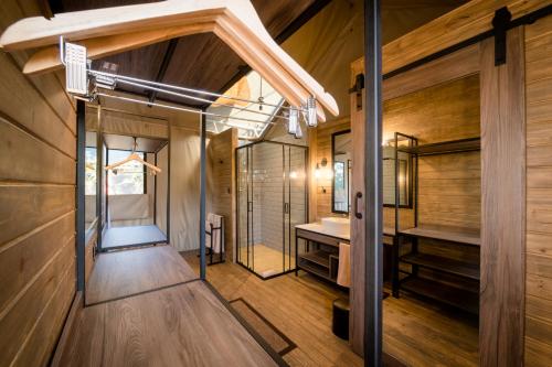 a large bathroom with a sink and a tub at Nkuhlu Tented Camp in Skukuza