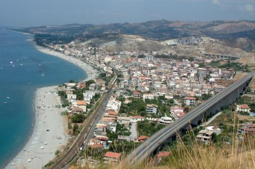 a view of a city with a bridge over a beach at civico 44 in Bova Marina