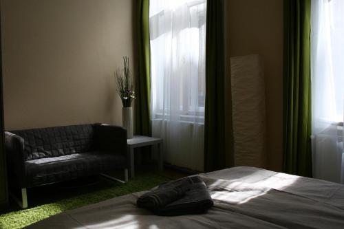 a bedroom with a bed and a chair and a window at Astoria Downtown in Budapest