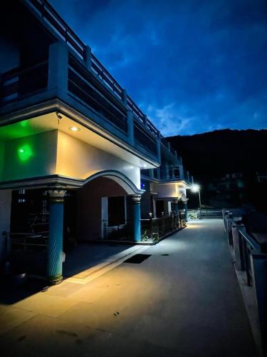 a lit up building with a street at night at Hotel Rajshree Palace in Gupta Kāshi