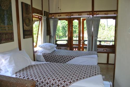 Кровать или кровати в номере Kura Kura Villas