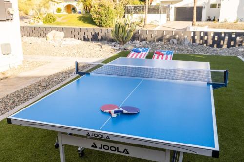 a ping pong table with two chairs on it at Phoenix 22nd St home in Phoenix