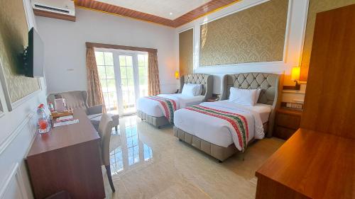 Postel nebo postele na pokoji v ubytování Gili Beachfront Suites