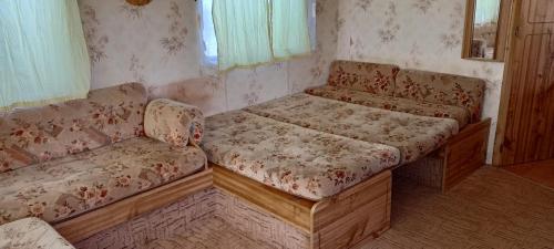 a couch and a chair in a room at Domek nad Stawami - Warmia in Jonkowo
