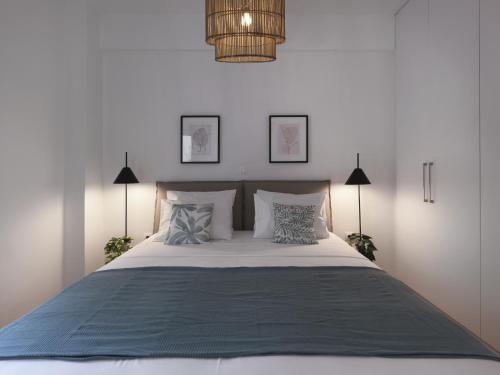a bedroom with a large white bed with pillows at Aiginitou6 in Athens