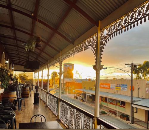 a building with a balcony with a view of a train station at Royal Hotel Sea Lake in Sea Lake