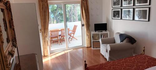 a living room with a couch and a chair and a balcony at villa petar apartment a4 with terrace in Ivan Dolac