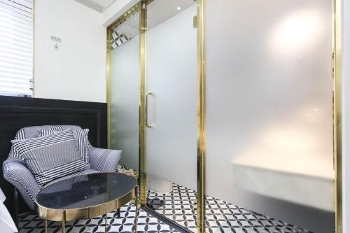 a living room with a table and a chair at The Post Hotel in Seoul