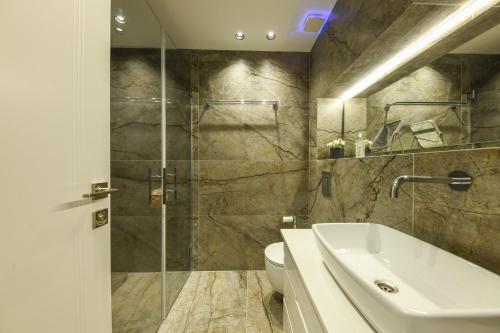 a bathroom with a shower and a sink and a toilet at Stunning Modern Studio in Netanya minutes from the beach by Sea N' Rent in Netanya