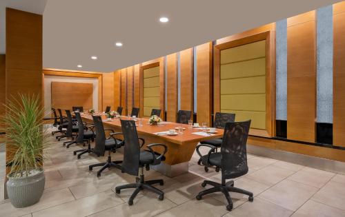 a conference room with a long table and chairs at Ginger Kochi MG Road in Cochin