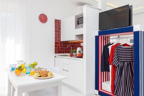 a kitchen with a refrigerator and a table at Pupatella Luxury Suite in Sorrento