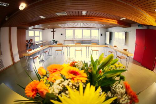 a room with a bunch of flowers on a table at Hotel & Bildungshaus St. Jodern in Visp