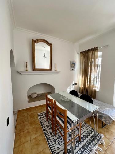 a dining room with a table and a mirror at Evangelia in Symi