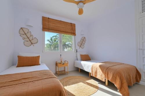 a bedroom with two beds and a window at Los Jazmines in Jávea