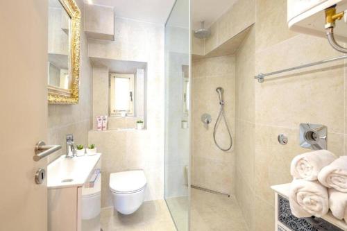 a bathroom with a toilet and a sink and a shower at Luxe Villa Ammarulla in Split