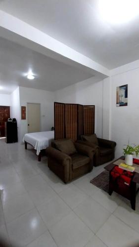 a living room with a couch and a bed at Panglao Budget Staycation & Guesthouse For Family ,Groups, and Friends in Panglao Island