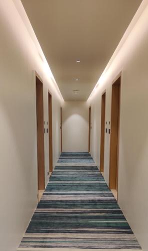 a corridor of an empty building with a long hallway at Regenta Place Raysons Kolhapur in Kolhapur