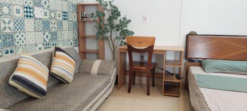 a living room with a couch and a desk at LeMin Homestay in Hai Phong