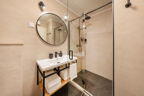a bathroom with a sink and a mirror at Apartment Fani with free private parking in Dubrovnik