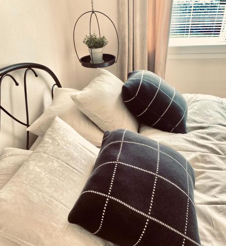a bed with two pillows on top of it at Ihana huoneisto - The Nest with Sauna in VAASA in Vaasa