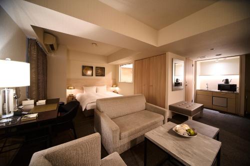 a hotel room with a bed and a living room at Roppongi Hotel S in Tokyo