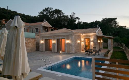 a villa with a swimming pool and a house at Villa Michalis in Liapades