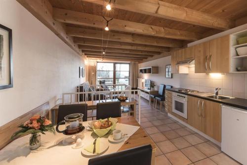 eine Küche mit einem Tisch und Stühlen im Zimmer in der Unterkunft Ferienwohnungen Nachbaur in Oberjoch