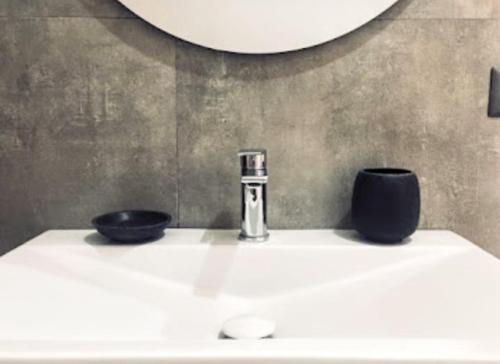 a bathroom sink with a faucet and two bowls on it at Il Mulino in Locri