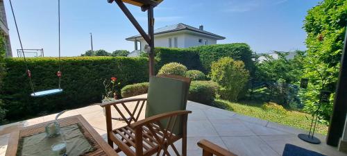 a patio with a chair and a table and a house at Blue Home in Balatonföldvár