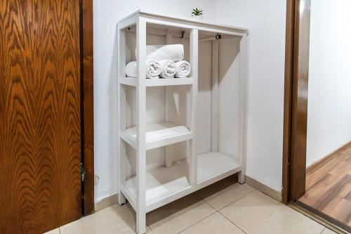 a white closet with white shelves in a room at Nof glili Mansion in Yavneʼel