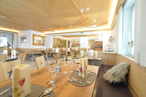 a dining room with a table and chairs and a restaurant at Apartment Traube - Stelvio in Stelvio
