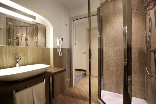 a bathroom with a sink and a shower at Hotel Ponti in Angera