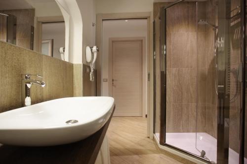 a bathroom with a sink and a shower at Hotel Ponti in Angera