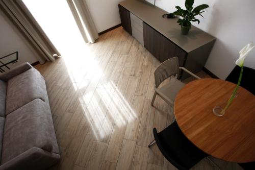 a living room with a table and a couch at Hotel Ponti in Angera