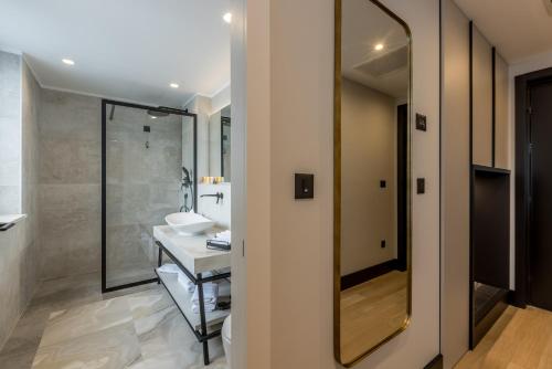 a bathroom with a sink and a mirror at Cora Hotel in Split