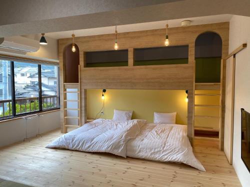 a bedroom with a bed and bunk beds in it at Hatsuneso Shinkan in Ureshino