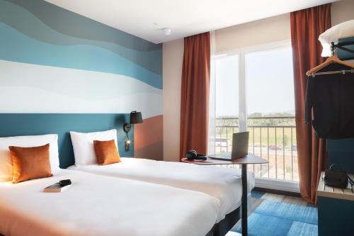 Ένα ή περισσότερα κρεβάτια σε δωμάτιο στο Ibis Styles Miramas