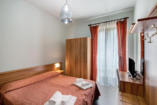 Ένα ή περισσότερα κρεβάτια σε δωμάτιο στο Residence Paradiso Bilocale 101